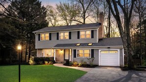 A two-story house with a garage, a well-maintained lawn, and a street lamp. - 4BR Family Retreat Near Annapolis w/ Large Yard (Annapolis)