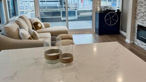 A modern kitchen with a marble countertop, a built-in island, and a view of the harbor. - 4-bedroom houseboat in historic Old Kuttawa, KY (Kuttawa)