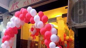 A hotel entrance with a sign reading "M.K. Hotel & Restaurant" and a decorative balloon arch. - M K Hotel And Restaurant (Jammu)