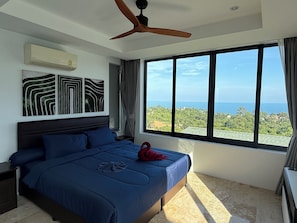 A bedroom with a large bed, a ceiling fan, and a view of the ocean. - Top Sea view villa Josephine. Close to Chaweng beach (Koh Samui)