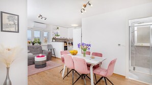 Un appartamento moderno con zona pranzo, soggiorno e cucina.
