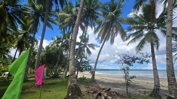 On the beach, white sand, sun loungers, beach umbrellas