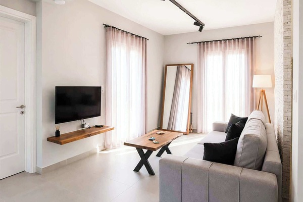 Contemporary open-plan lounge area with plenty of natural light and modern décor. Perfect for relaxing after visiting nearby beaches or exploring