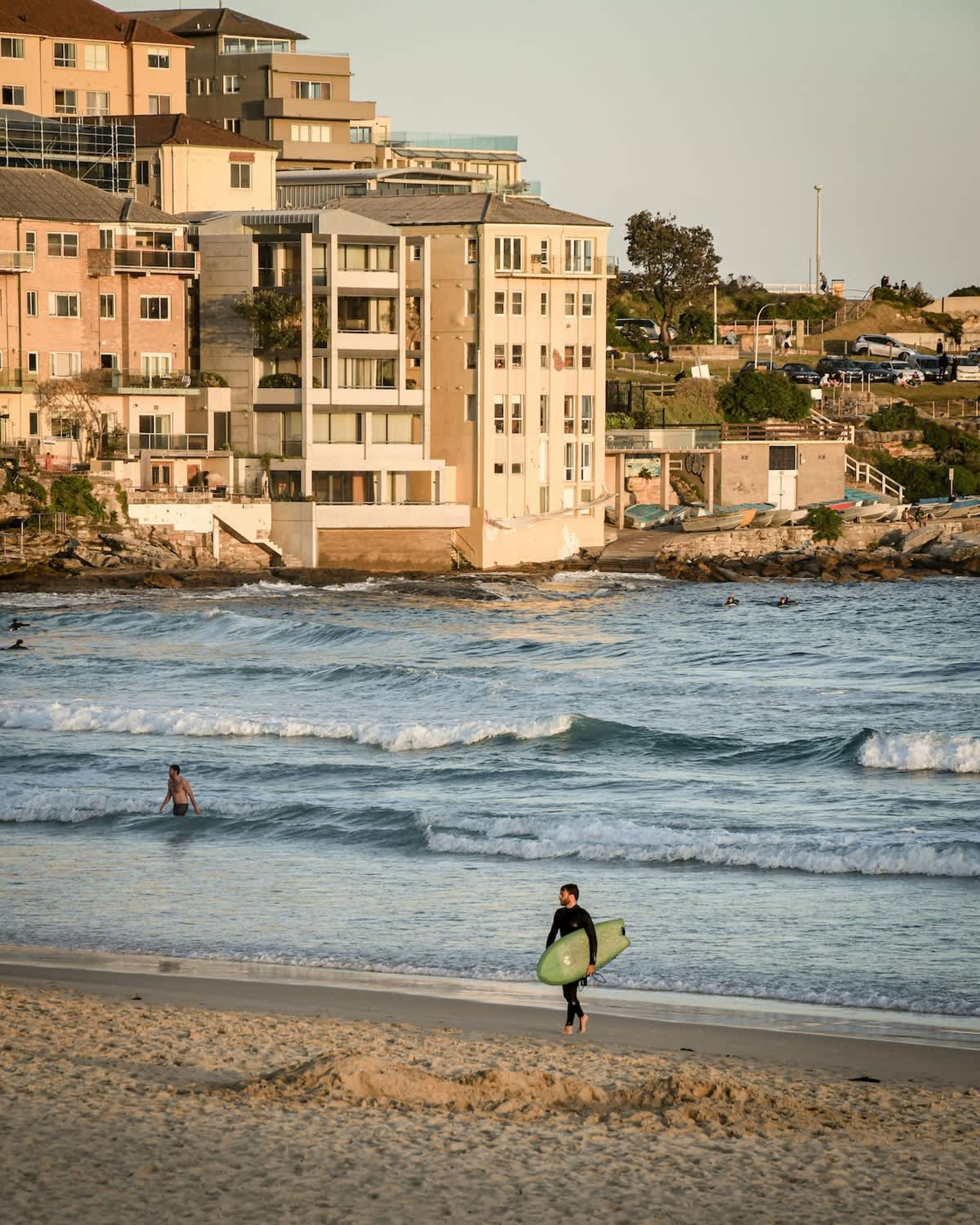 A coastal area with buildings, a beach, and the ocean.