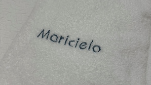 A white towel with the word "Maricielo" embroidered on it. - Unbeatable location, first line of the beach in the middle of Silgar promenade. (sanxenxo)