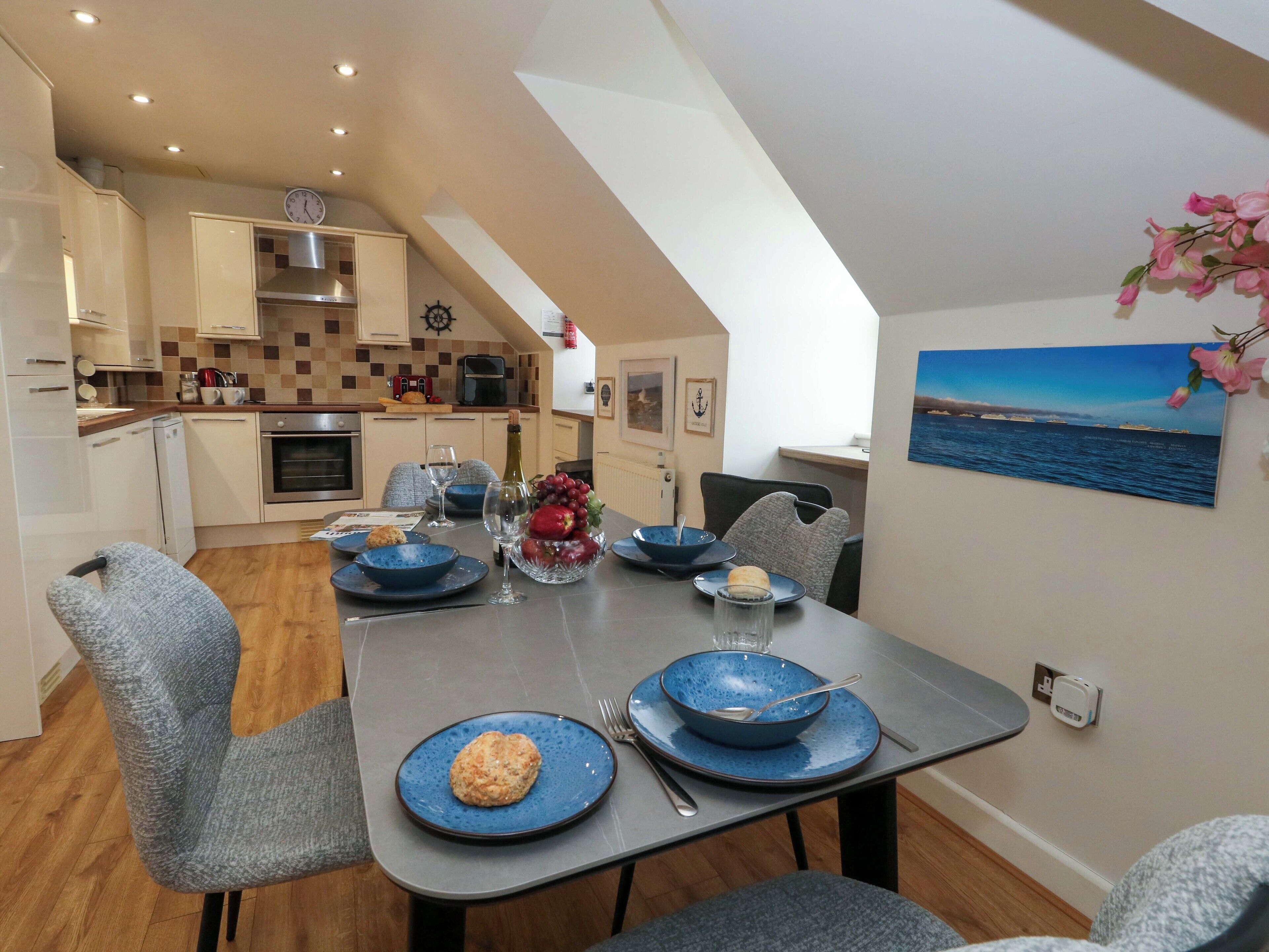 A modern kitchen with a dining area.