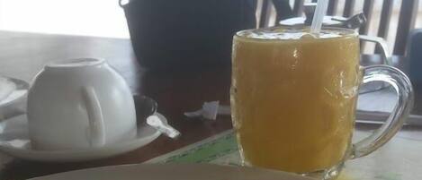 A table with a plate of toast and a glass of orange juice.