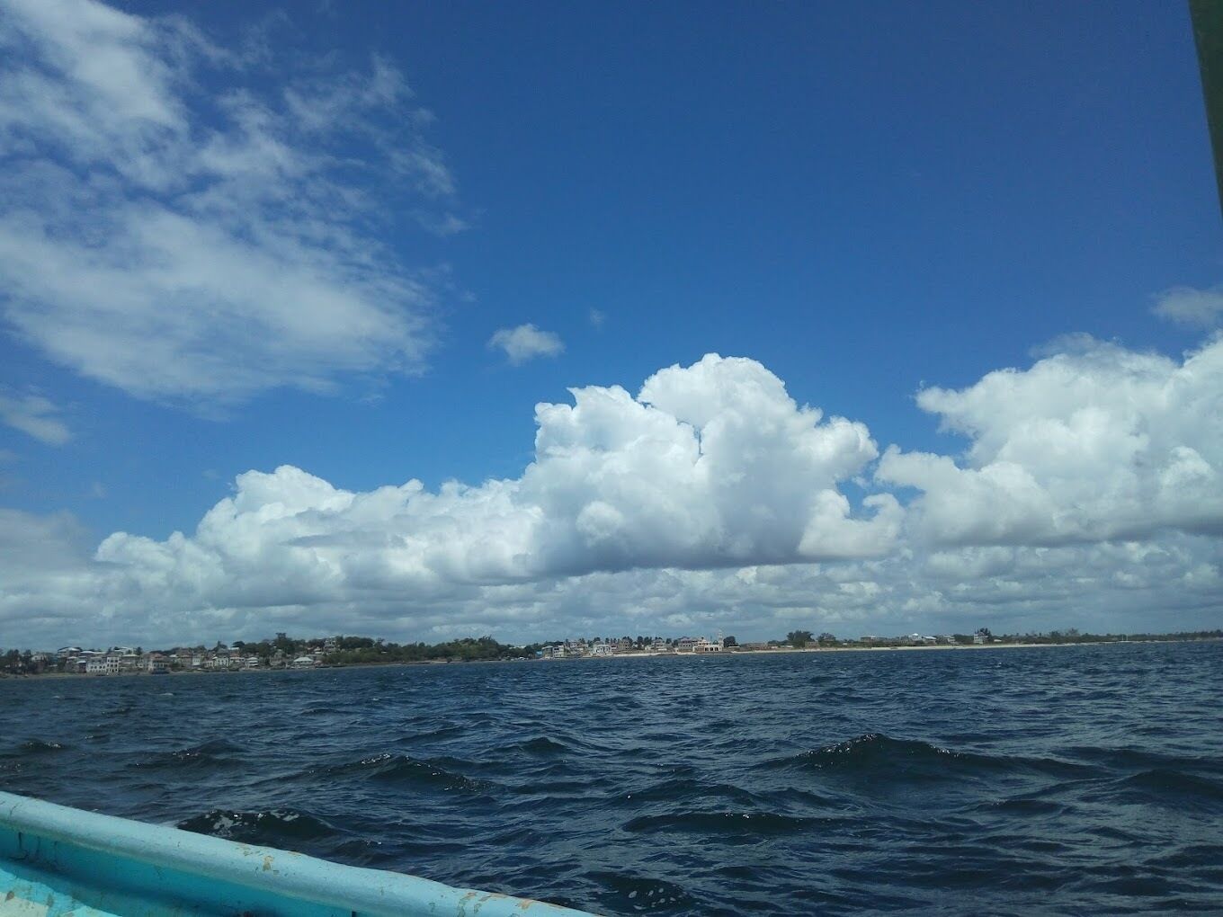 A coastal view with a clear sky and a body of water.