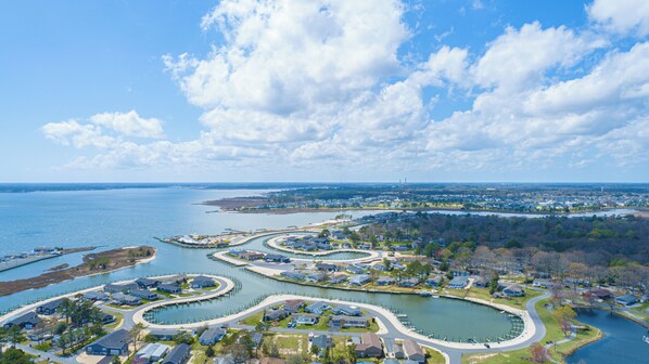 A residential area with a marina, houses, and a large body of water. - Lovely home, beach, pools, family fun, pet friendly! (Long Neck)