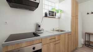 A modern kitchen with a built-in microwave, stove, and sink.