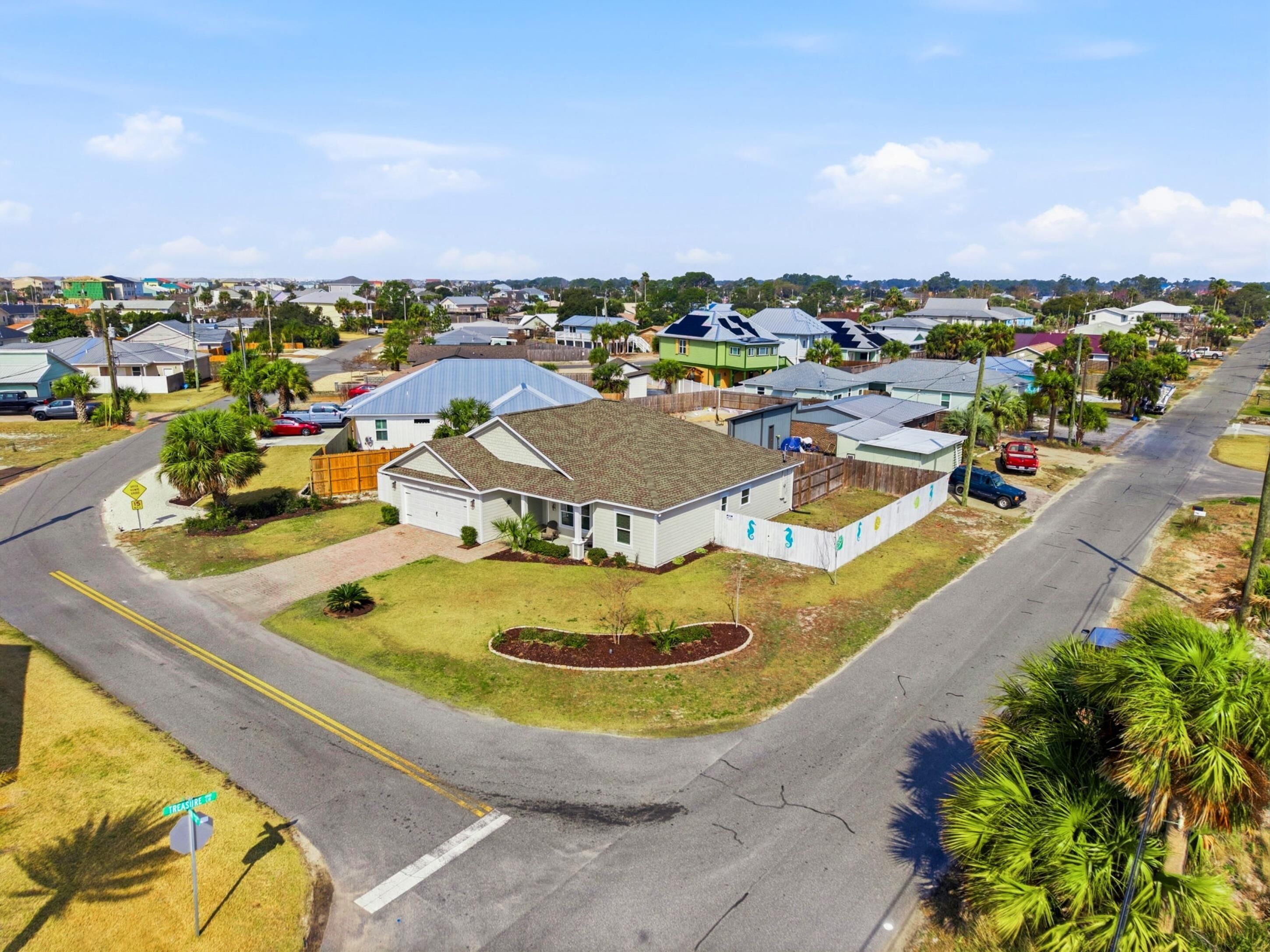 A residential area with houses, roads, and a street sign indicating 'TREASURE ST'.