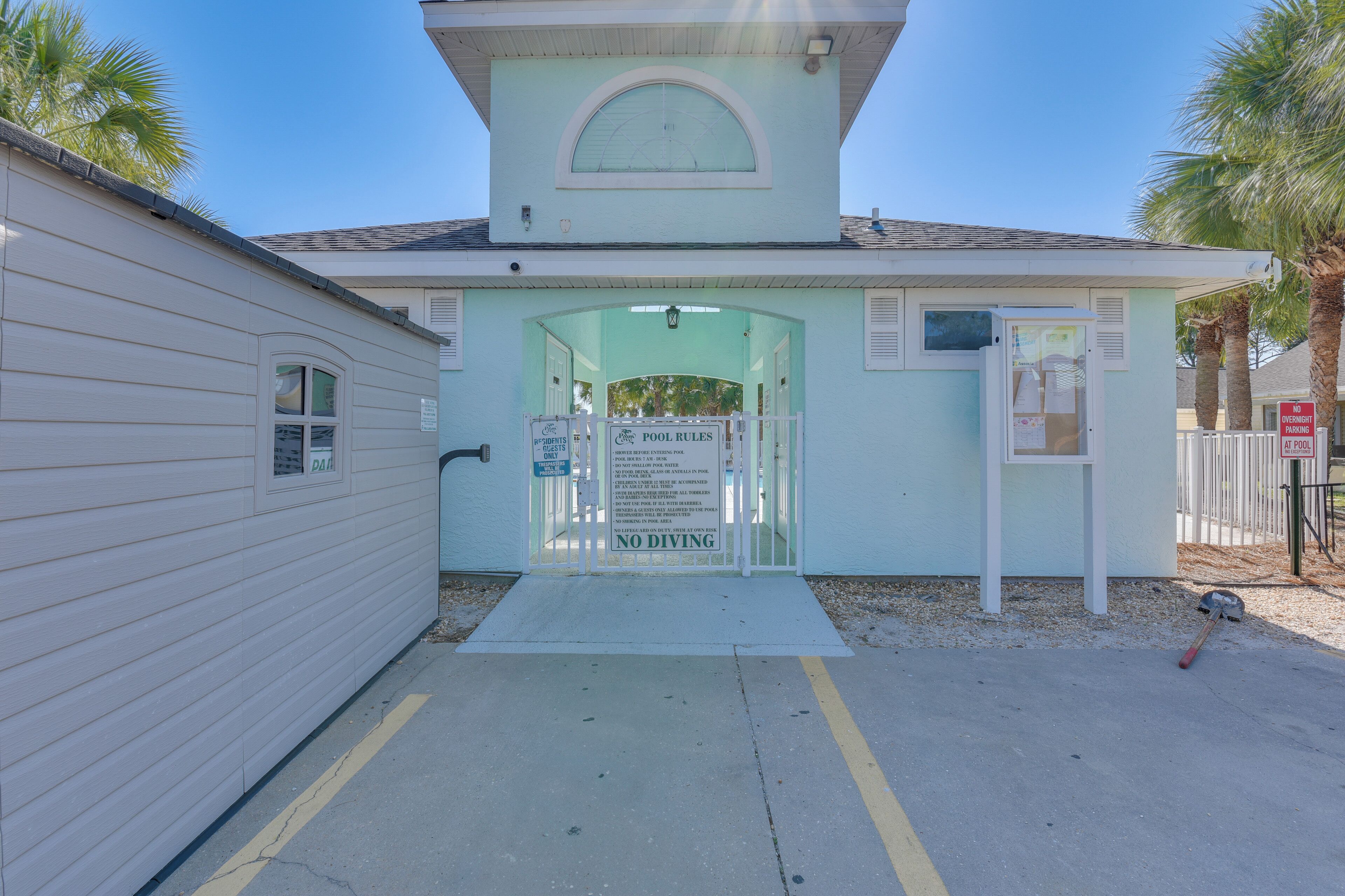 A small building with a covered entrance and a sign indicating no diving.