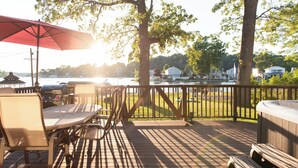 A wooden deck with a table and chairs, a grill, and a hot tub. - Family Summer Getaway w/ Hot Tub on Lake Hopatcong (Lake Hopatcong)