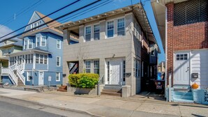 A two-story residential building with a front porch, a staircase, and a small garden area. - 2 Blocks to Beach & Boardwalk: Ventnor City Escape (Ventnor City)