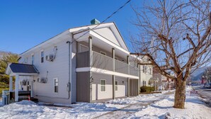 A two-story house with a covered front porch and a 'For Rent' sign. - Explore the Hinton Historic District! Luxe Studio (Hinton)