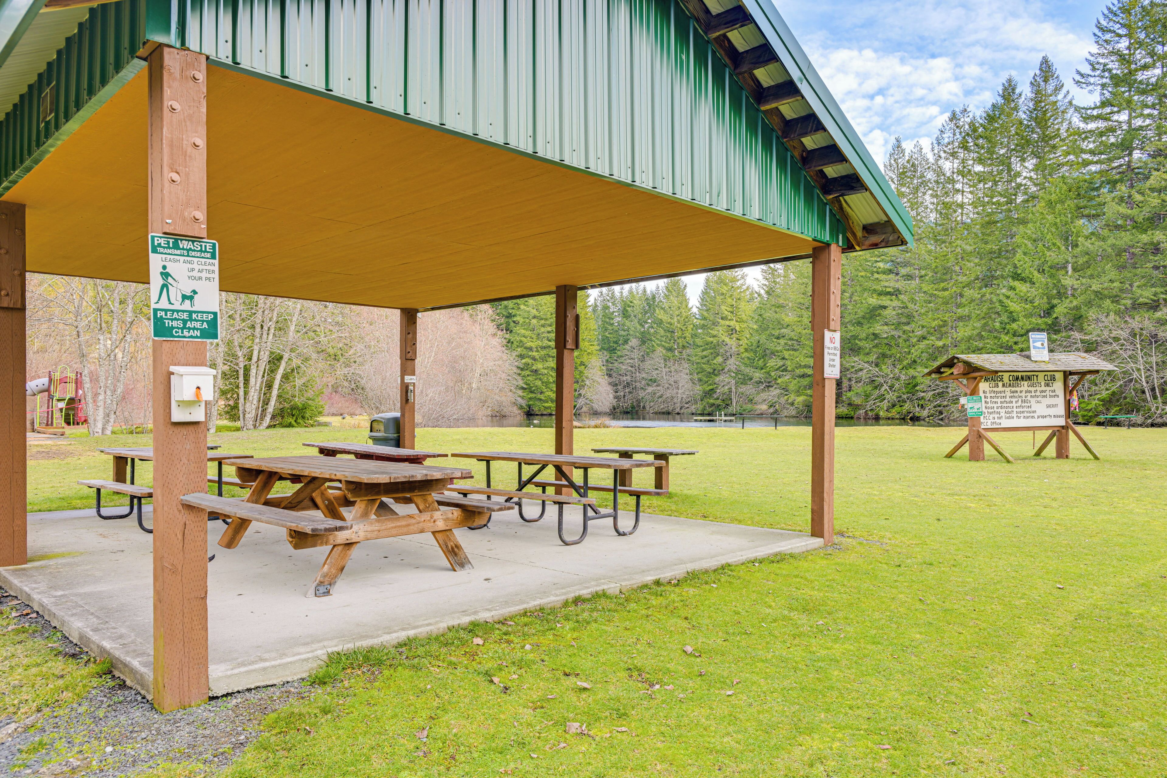 A covered picnic area with picnic tables and a shelter.