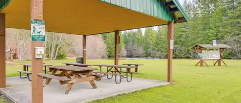 A covered picnic area with picnic tables and a shelter.