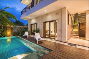 A modern house with a swimming pool, a wooden deck, and a staircase leading to the upper floor. - 3 BR, 250 Sqmt Villa, Terrace, 10 min Available (Canggu)