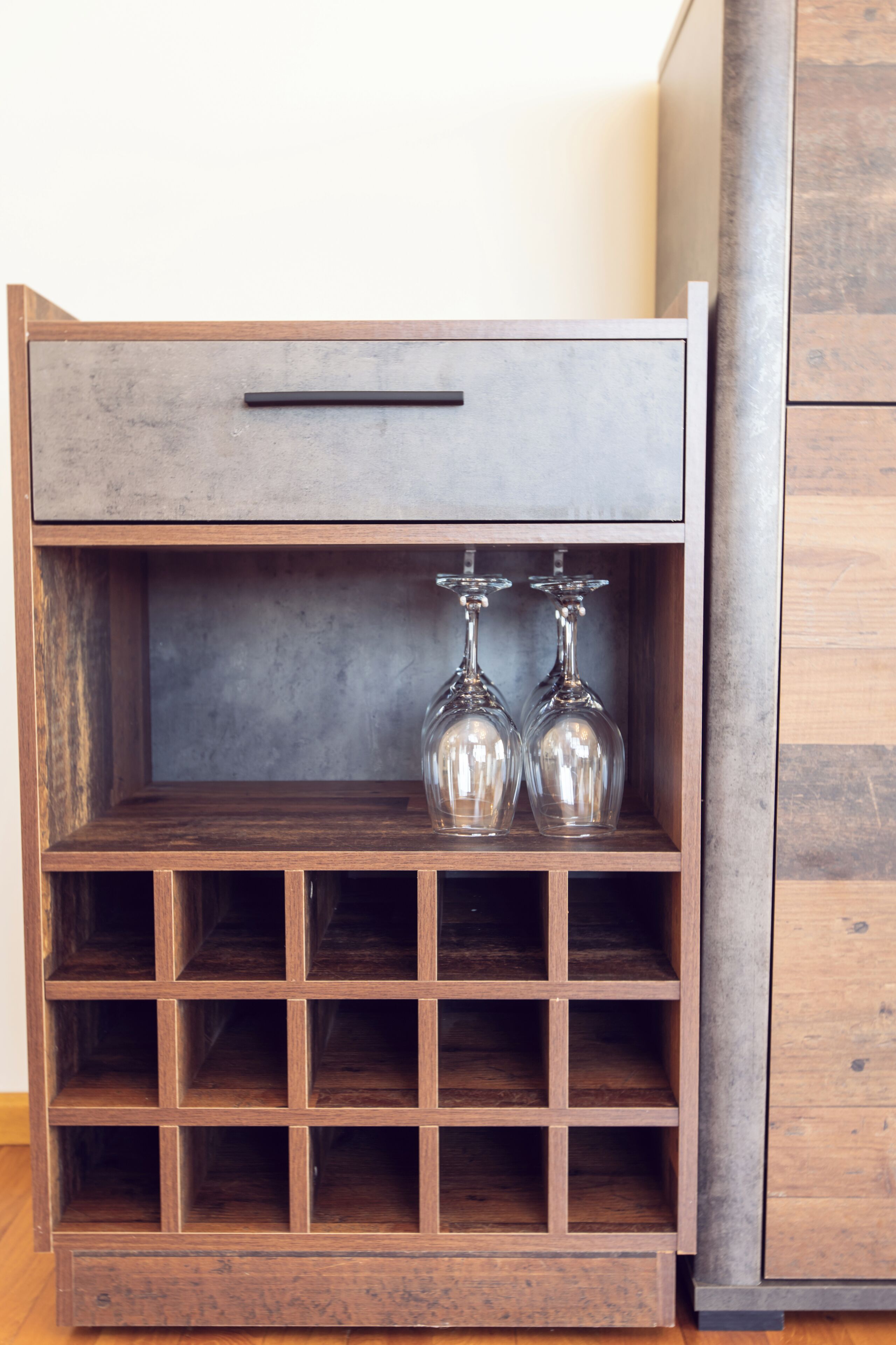 A wooden cabinet with a drawer and multiple shelves.