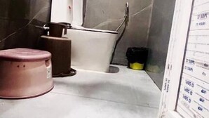 A bathroom with a bathtub, a toilet, and a sink. There is a mirror on the wall and a shower curtain. - Hotel Shree Kanhaiya Palace vrindavan  (Vrindavan)
