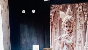 A reception area with a statue, two modern chairs, a water dispenser, and a reception desk. - Hotel Shree Kanhaiya Palace vrindavan  (Vrindavan)
