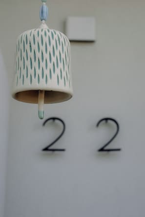A hanging lamp with a blue and white pattern, hanging above the number 22 on a wall. - A cosy home away from home! (Mandogalup)