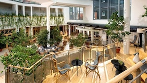 A spacious atrium with multiple levels, wooden flooring, and a variety of seating arrangements. - Sunday Resort Marina 2-bedroom (Rheinsberg)