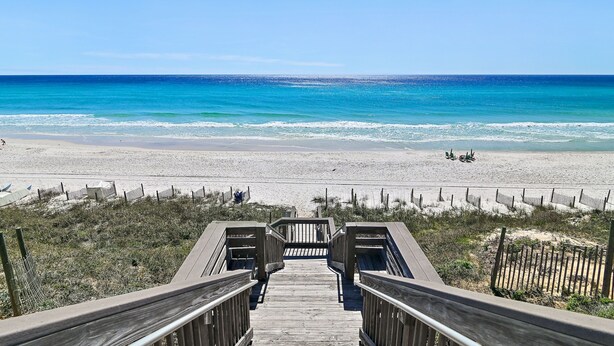 A wooden boardwalk leading to a beach with clear blue water and sandy shore. - Gulf Front Condo | Private Beach Access | Walk to Rosemary & Alys (Inlet Beach)