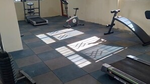 A gym with exercise equipment including a treadmill, stationary bike, and elliptical machine. - Stylish 2BR Kilimani Retreat | Lift, Fast WiFi & Family-Friendly Comfort (Nairobi)