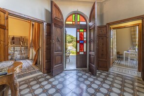 A spacious hallway with a tiled floor, wooden doors, and a stained glass window. - Villa Liberty: Historic Villa with Private Pool (Parrana San Martino)