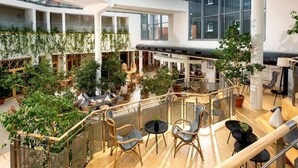 A spacious atrium with multiple levels, wooden flooring, and a variety of seating arrangements. - Sunday Resort Marina 3-bedroom Apartment (Rheinsberg)