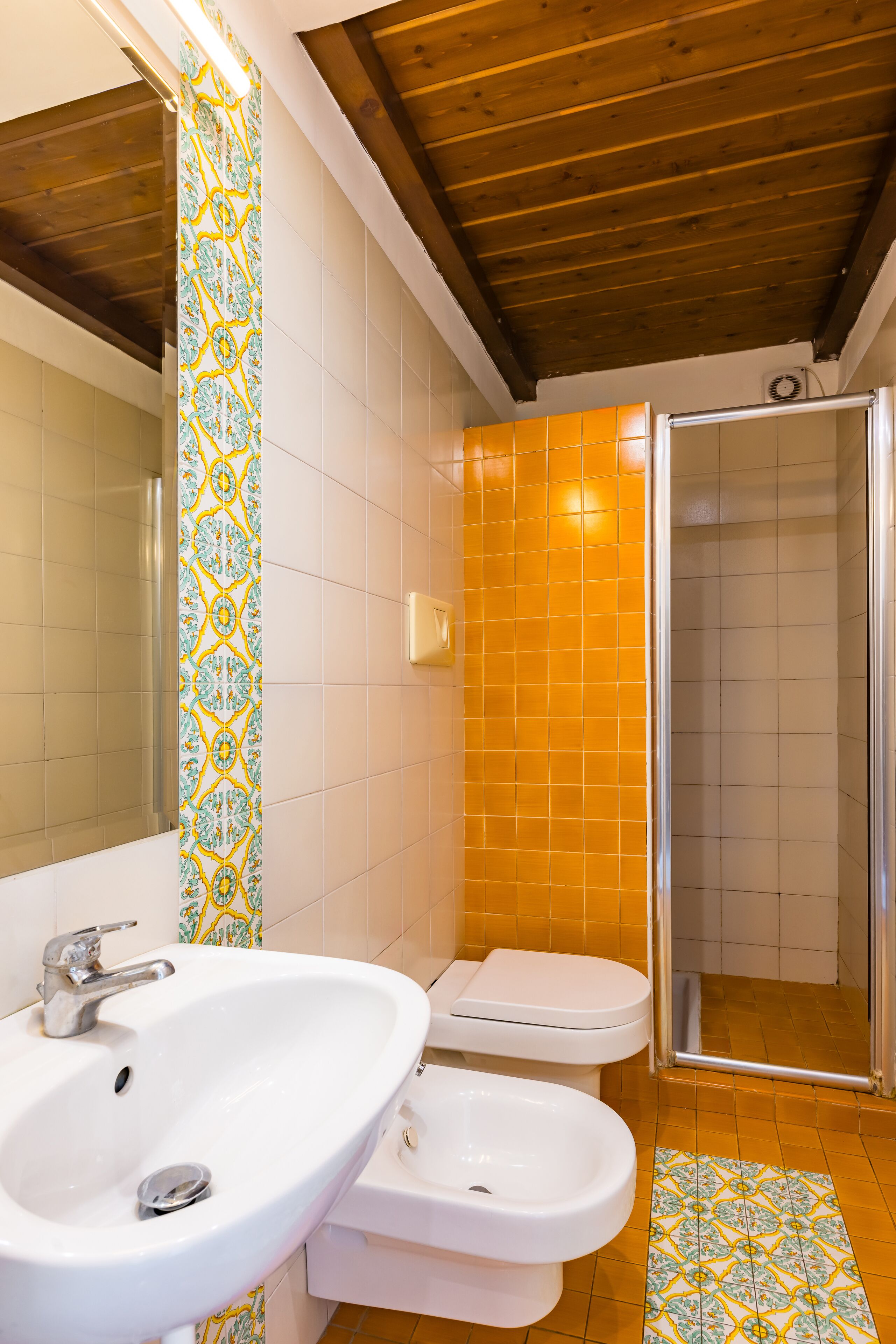 A bathroom with a white sink, a toilet, and a shower.