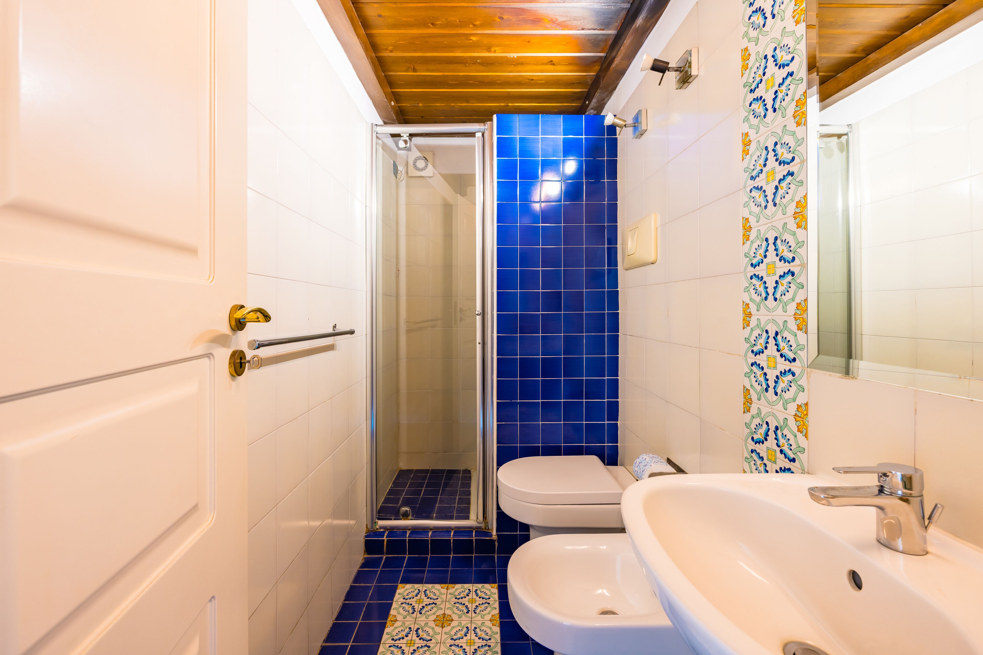 A bathroom with a shower, toilet, and sink.