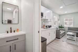 A modern kitchen with white cabinets, a built-in oven, and a microwave. - Charming 1BD 1BA, Central Loc! (Severn)
