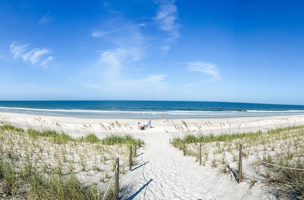 A beach path leading to the ocean with sand dunes and sparse vegetation. - New listing! Luxury beach escape, 2 blocks to the ocean, 1 block to the river! Heated saltwater pool, spa, sauna, game room, golf cart—only 10 mins to downtown St. Augustine. Very clean, well stocked, perfect for couples, families & small groups. (St. Augustine)