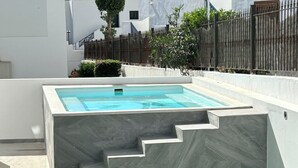 A rectangular swimming pool with a stone exterior and a set of stairs leading up to it. - Sunning 2 bedrooom apartment 5 minutes walk to seafront. (Tías)