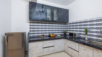 Fridge, microwave, cookware/dishes/utensils, dining tables