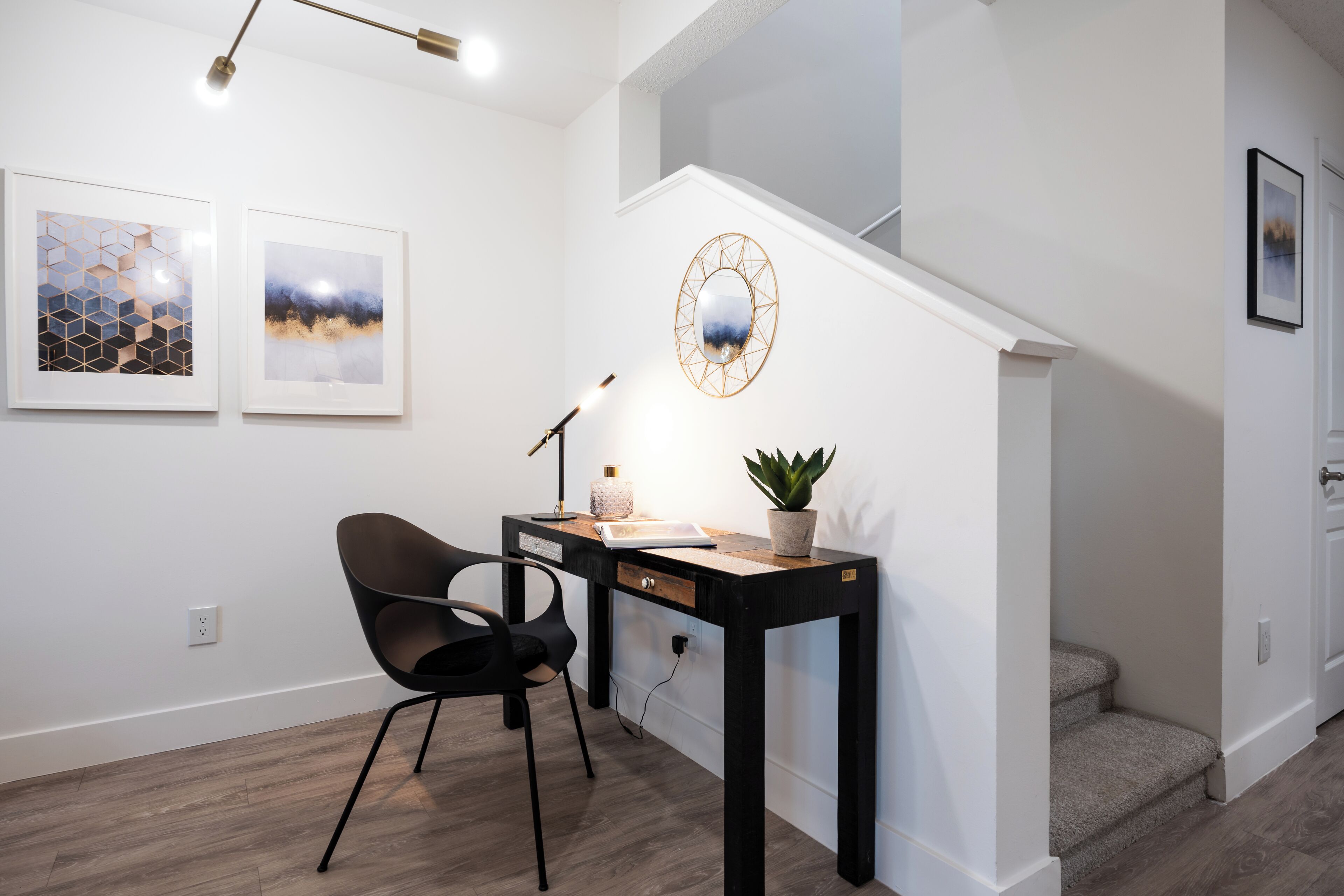 Un espace de bureau moderne comprenant un bureau, une chaise et une plante en pot.