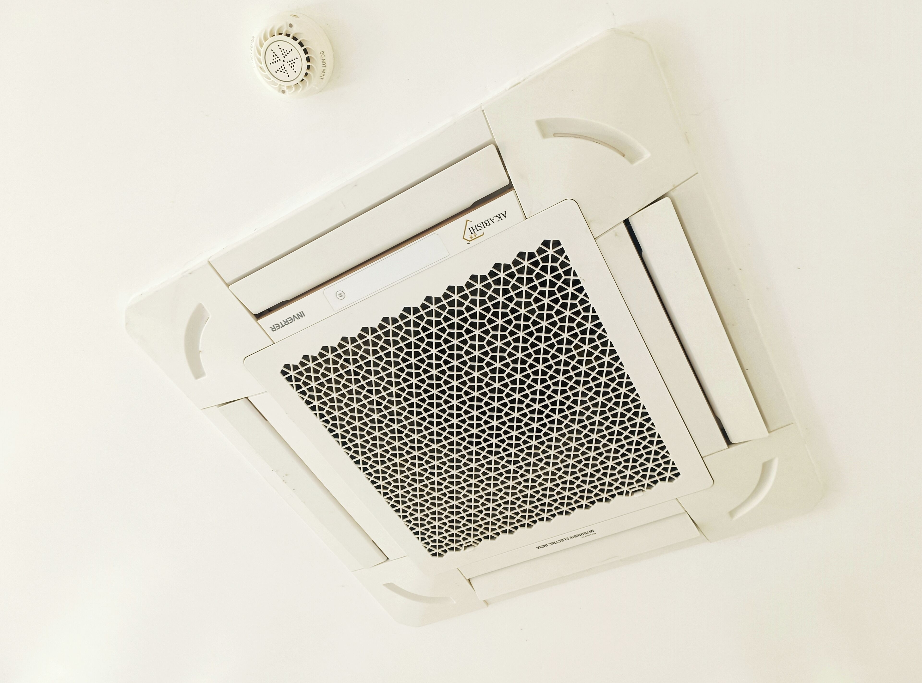 A white air conditioning unit with a honeycomb pattern grille, a control panel with a power button, and a 'DO NOT FLY' label.