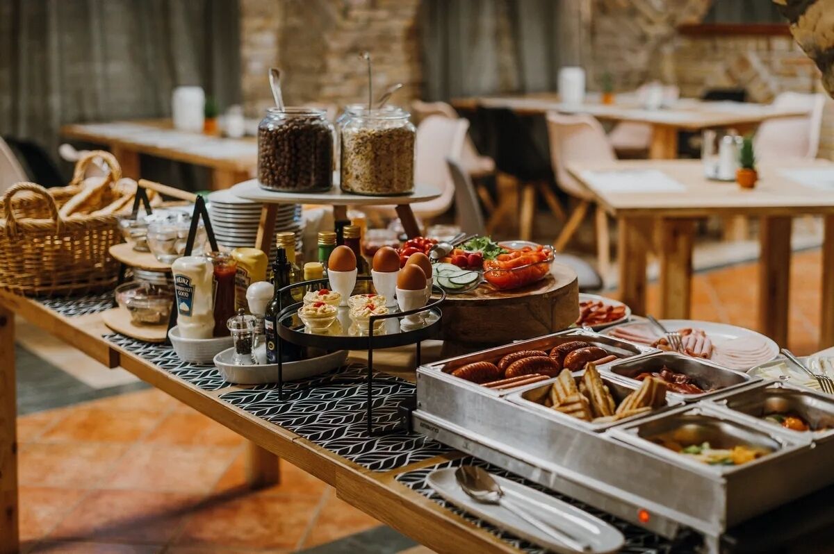 A buffet with various food items and condiments.