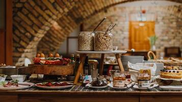 A breakfast buffet with various food items and condiments.