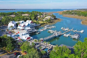 A marina with boats docked, a waterfront restaurant, and a view of the water. - Private Pool | Walk to Beach | 3BR Retreat (Hilton Head Island)