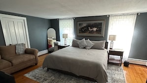 A bedroom with a bed, a sofa, a desk, and a chair. - Rubicon farmhouse minutes from Erin Hills Golf course, Holy Hill, & Bowery Barn (Rubicon)