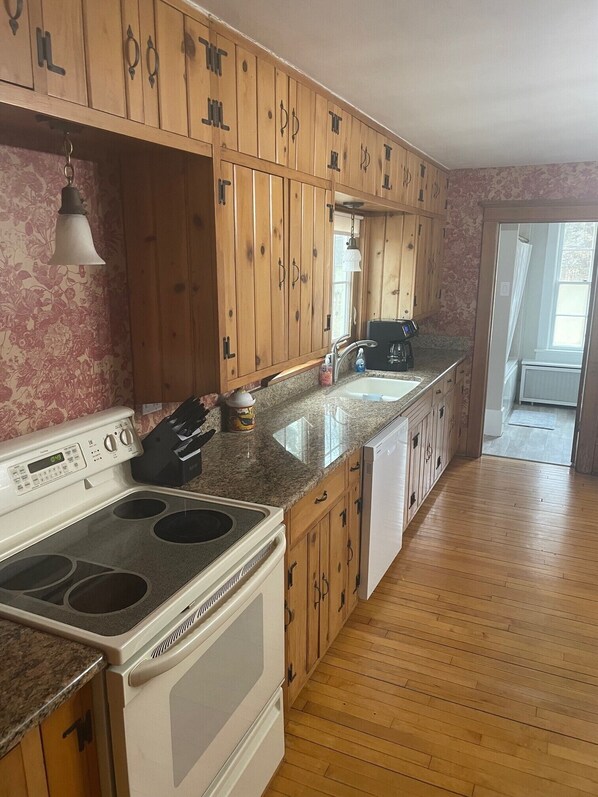 A kitchen with wooden cabinets, a stove, a sink, and a countertop. - Rubicon farmhouse minutes from Erin Hills Golf course, Holy Hill, & Bowery Barn (Rubicon)