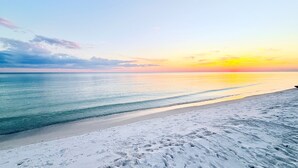 A beach with a clear sky and calm sea at sunset. - Charming Carillon Home + Kid Friendly + Lots of Extras (Panama City Beach)