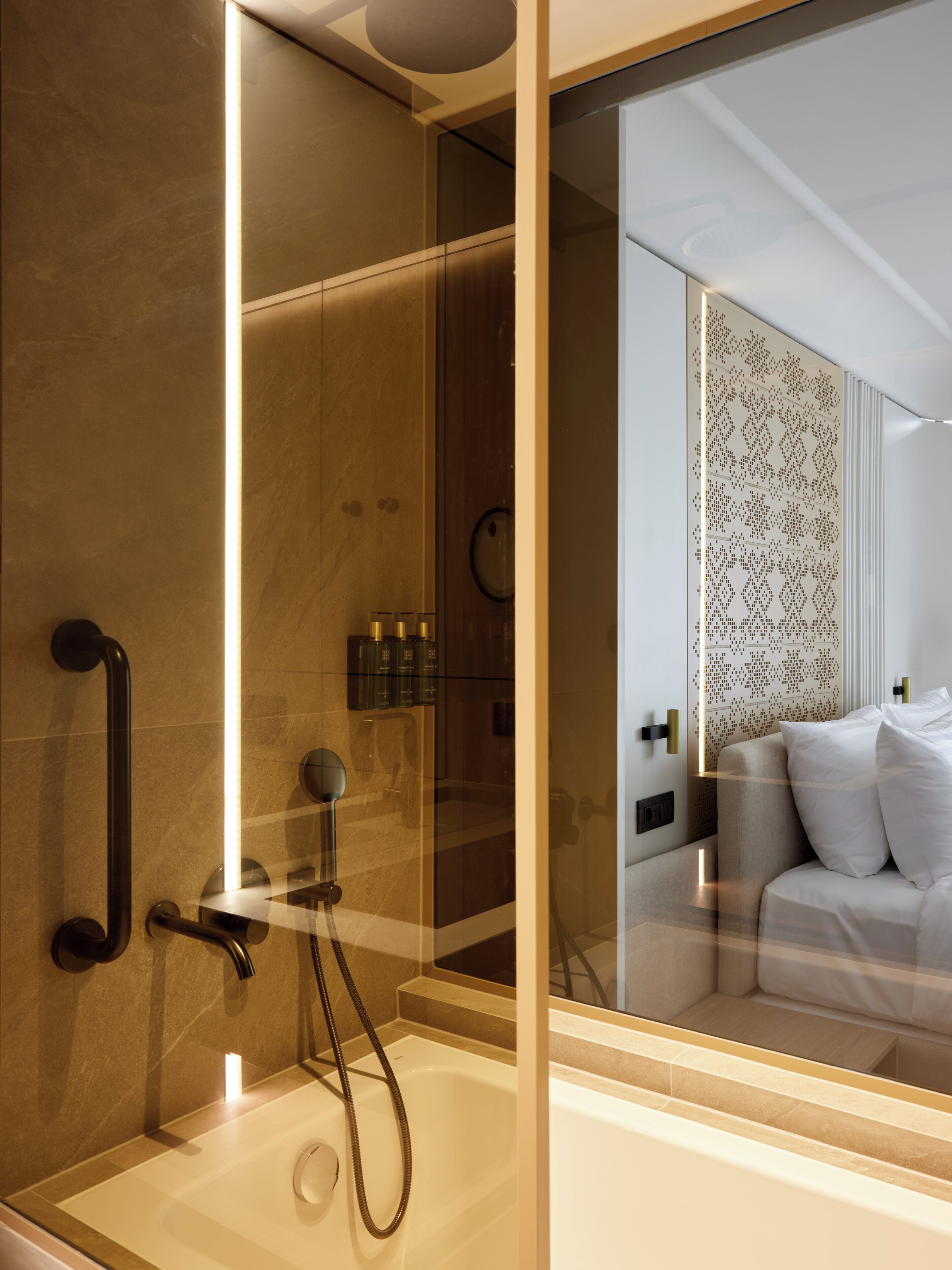 A modern bathroom with a glass-enclosed shower, a bathtub, and a visible toilet.