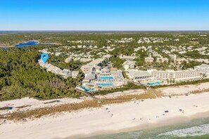 An aerial view of a coastal resort with multiple buildings, a beach, and a large pool area. - 🏖️Watercolor 30A | Bikes Included | 3 Pools | Walk to Beach | Sol Y Sombra🏖️ (Santa Rosa Beach)