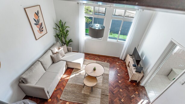 Un salon moderne avec un canapé, une table basse et un téléviseur.