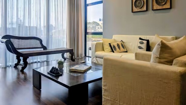 A modern living room with a sofa, a bench, and a coffee table. - 2 Bedroom Apartment in Colombo 05 (Colombo)