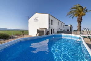 A swimming pool with a white building labeled 'MASIA Clambrich' in the background. - Country House 'Marisma' with Shared Pool, Wi-Fi and Air Conditioning (Deltebre)